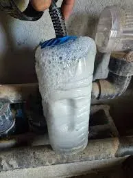 Cellule d’électrolyseur plongée dans une solution de détartrage, couverte de mousse pendant que le calcaire se dissout